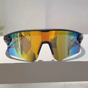 Detail of polarized cycling sunglasses with orange-blue gradient lenses and matte black frame