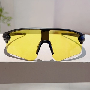 Macro shot of sports sunglasses with high-contrast yellow lenses and black matte frame