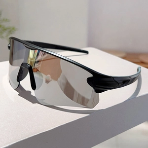 Detail of black sports sunglasses with silver mirrored lens on a minimalist white block