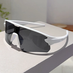 Detail view of white cycling sunglasses with wrap-around grey lenses on a grey stand