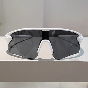 Front view of white sports sunglasses with large grey lens for cycling and running
