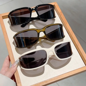 Y2K futuristic rectangular sunglasses in black, amber, and beige colors