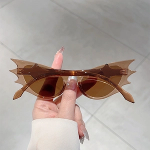 Detail view of amber flame-shaped sunglasses with brown lenses for hip-hop style
