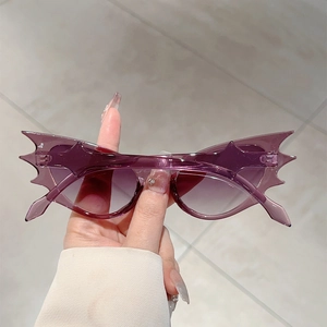 Macro shot of purple translucent bat-shaped hip-hop sunglasses with sharp geometric frames