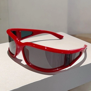 Close-up of red Y2K wraparound sunglasses with dark gray lenses on a white display stand