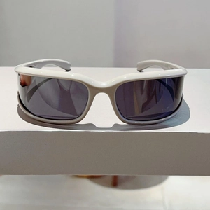 Detail of white wrap-around sunglasses frame with dark lenses in Y2K futuristic style