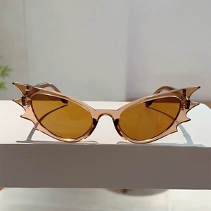 Detail shot of bat-shaped amber tinted lenses on a white display stand