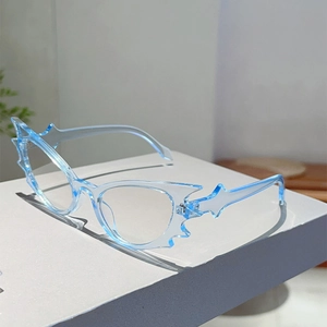 Detail view of light blue flame-shaped avant-garde sunglasses with transparent resin frames