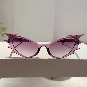 Detailed view of purple bat-shaped sunglasses with gradient lenses for party costumes