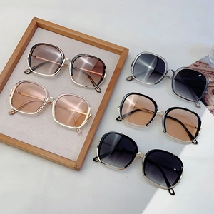 Square metal frame sunglasses in five colors with gradient lenses on marble background