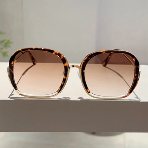 Detail of square leopard print sunglasses with gradient lenses and gold metal temples