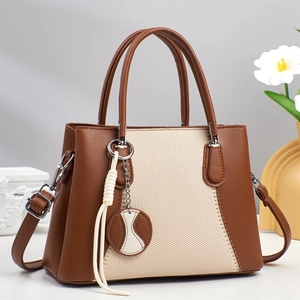 Brown and beige patchwork tote bag with woven panel and adjustable crossbody strap