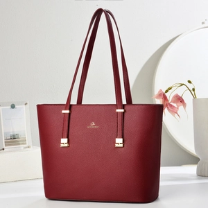 Deep red leather tote bag with gold hardware and top handle for elegant commute use