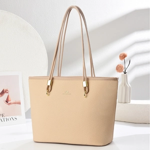 Close-up of woven texture and metal ring detail on elegant beige large tote bag