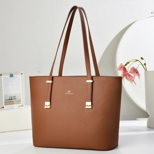 Close-up of brown lychee pattern leather tote bag with gold logo and hardware details