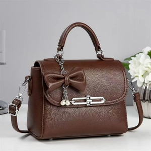 Elegant dark brown textured crossbody bag with leather bow and pearl chain charm detail