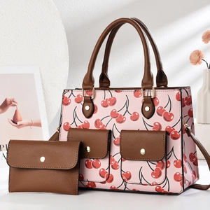 Brown PU tote bag with pink cherry prints and matching flap wallet on a white background