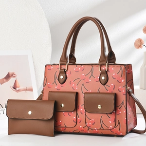 Detail shot of vintage cherry print tote bag with brown handles and matching wallet set