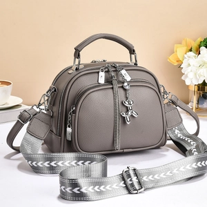 Gray lychee grain leather tote bag with three zipper pockets and a wide patterned strap