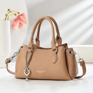 Elegant camel lychee leather handbag with heart chain and adjustable crossbody strap