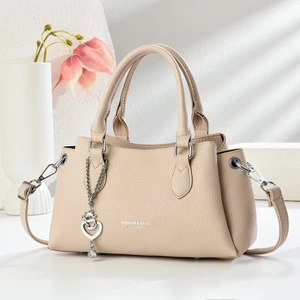 Chic beige lychee leather handbag for women with silver heart charm and crossbody strap