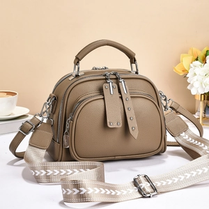 Litchi pattern leather crossbody bag with three zippers and ethnic woven strap