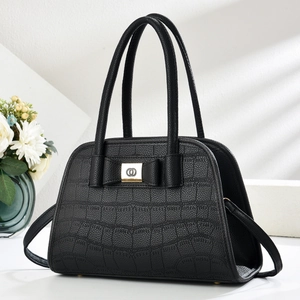 Chic black crocodile embossed handbag with bow decoration and adjustable shoulder strap
