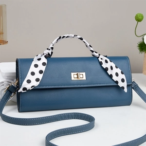 Dark blue pebbled leather crossbody bag with polka dot scarf and gold twist lock