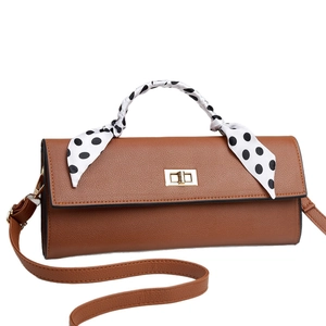 Brown faux leather crossbody bag with gold lock and polka dot silk scarf handle