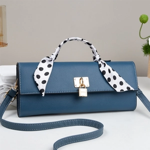 Blue lychee grain leather crossbody bag with gold lock and polka dot scarf detail