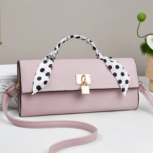 Pink leather handbag with a polka dot silk scarf handle and golden metal buckle clasp