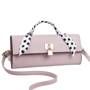 Pink lychee grain leather handbag with gold padlock and polka dot scarf handle detail