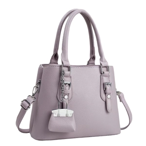 Elegant purple lychee leather handbag for women featuring silver hardware and a small charm