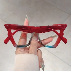 Close-up of stylish thick-frame blue light glasses with red and blue gradient finish