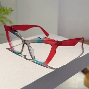 Detail view of geometric blue and red gradient glasses on a white minimalist block