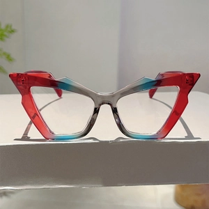 Detail of fashion-forward blue light blocking glasses with red and blue gradient frames