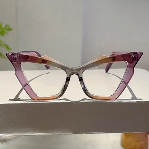 Detailed front view of cat-eye frames with purple to champagne gold gradient finish