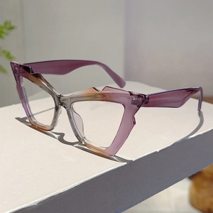 Detail of cat-eye anti-blue light glasses with purple-orange gradient frame on display