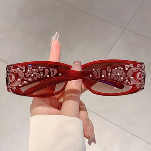 Detail of red rectangle sunglasses with floral print and crystal rhinestones