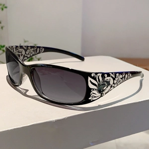 Detail of sunglasses featuring floral printed temples with sparkling rhinestone accents