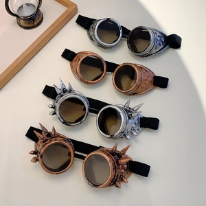 Detail view of steampunk goggles in bronze and silver finishes with punk spikes and straps
