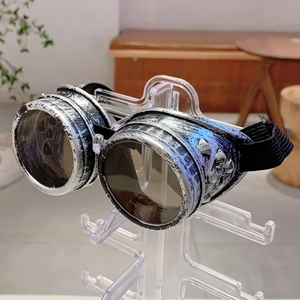Detail of retro steampunk goggles with metallic rivet frames and adjustable elastic strap