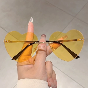 Trendy heart shaped rimless sunglasses with orange gradient lenses and gold metal bridge