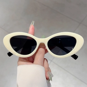 Retro cream oval sunglasses with black lenses and two-tone frames for a vintage look