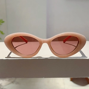 Close-up of trendy pink jelly cat-eye sunglasses with thick frames on white display