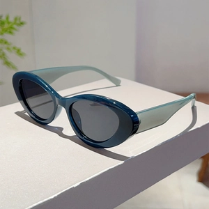 Side view of retro cat-eye sunglasses with deep blue frames and translucent temples