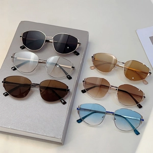 Chic polygonal metal sunglasses with various lens colors displayed on a book