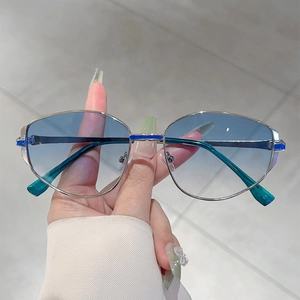 Detail of silver metal frame sunglasses with blue gradient lenses and enamel accents