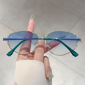 Detail of silver metal frame sunglasses with light blue gradient lenses and colored temples