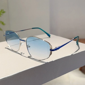 Detail of silver polygon metal frame sunglasses with blue gradient lenses and nose pads